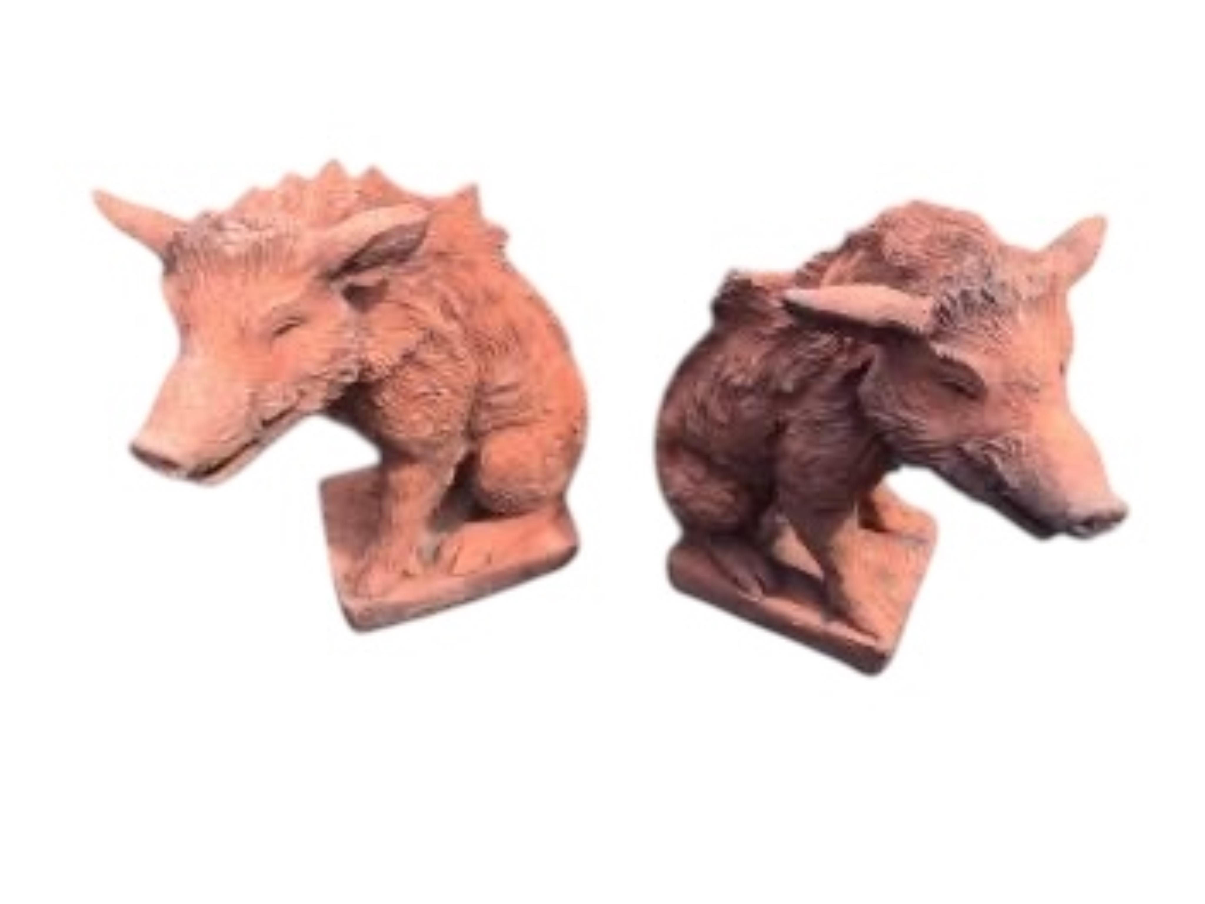A pair of terracotta seated wild boar garden ornaments, height 55cm